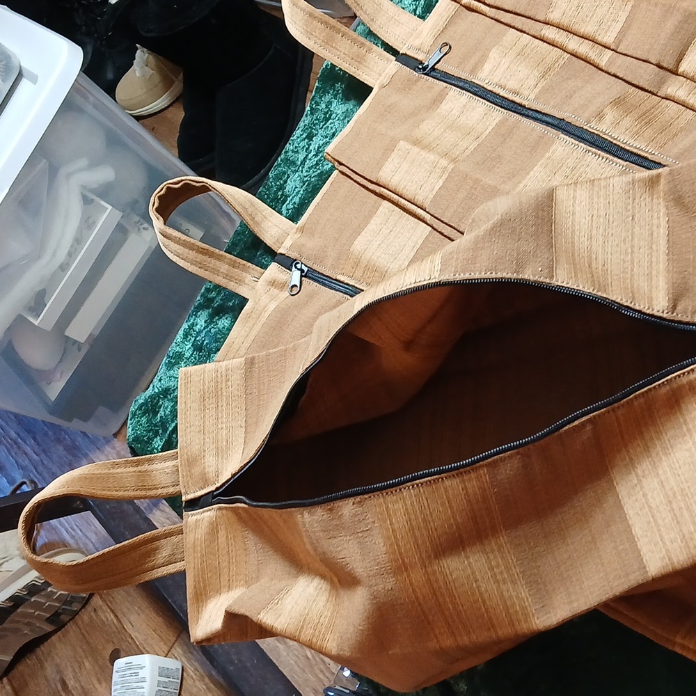 Accordion style shoe carrier, or can carry a bottle of wine.